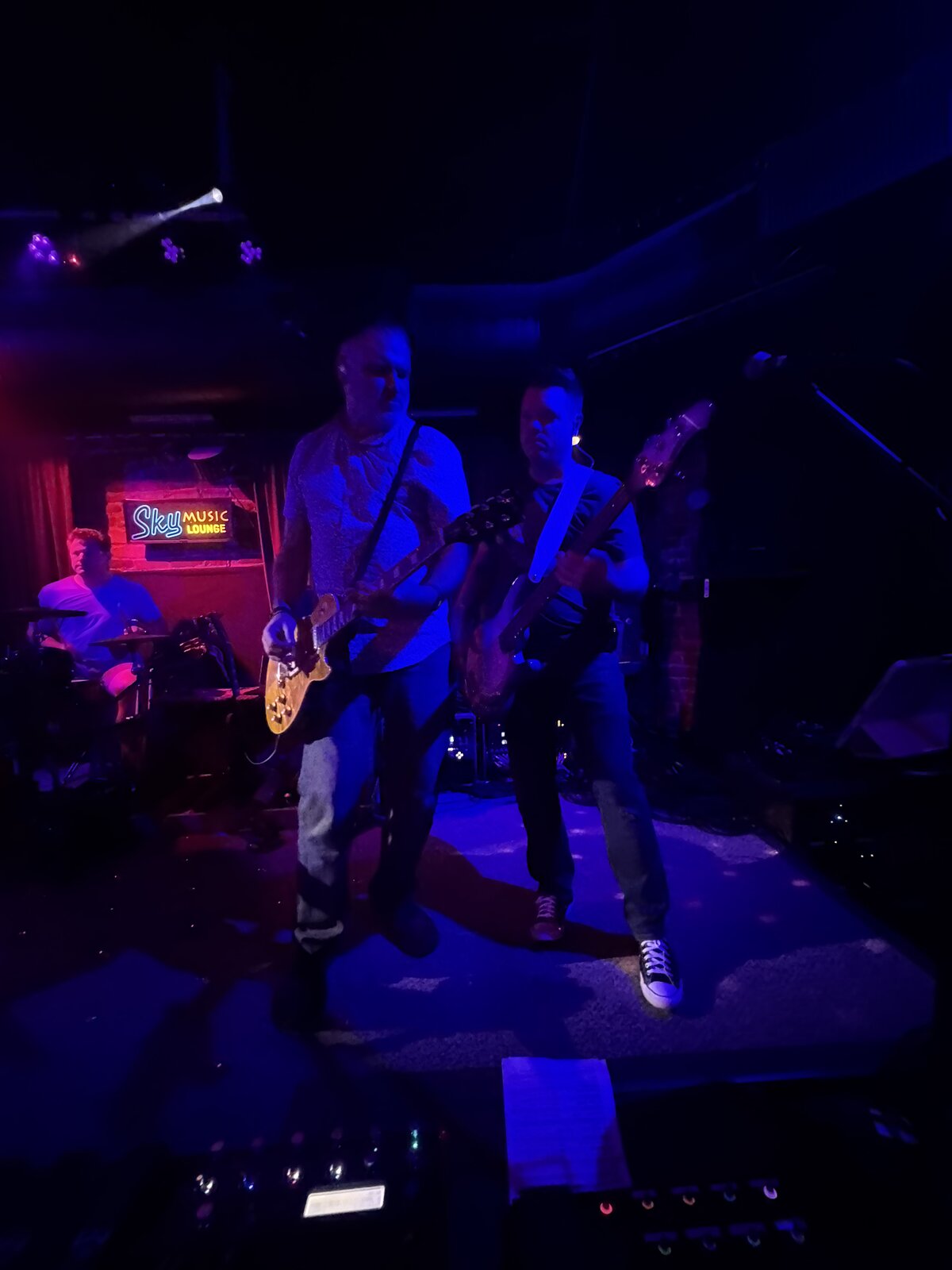 Larceny lead guitarist Kevin and bassist Tim on stage with drummer John at Sky Music Lounge