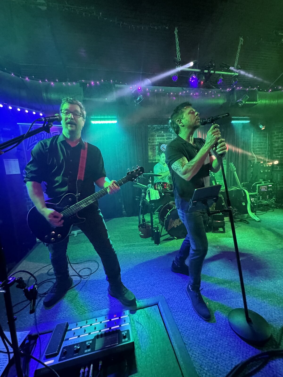 Larceny rhythm guitarist Dan and vocalist Erik rocking out on stage at Sky Music Lounge