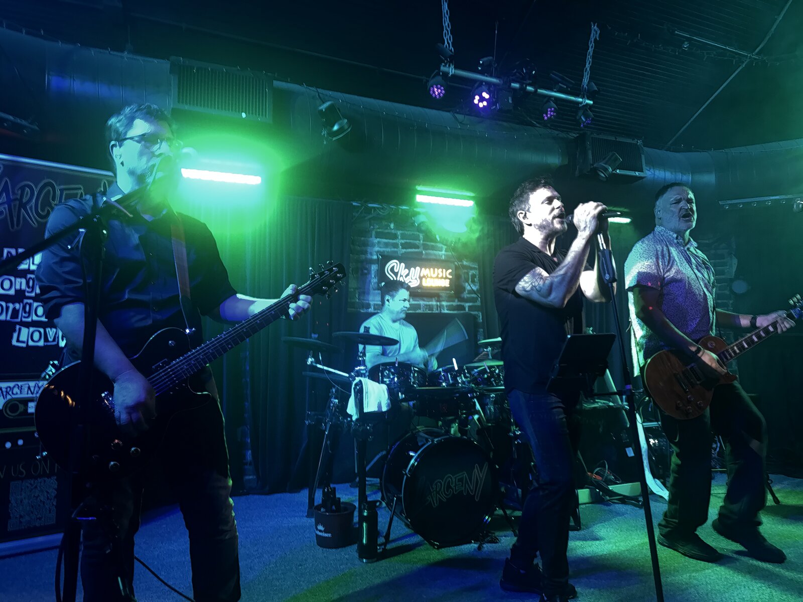 Larceny performing live with Dan, Erik, and Kevin at Sky Music Lounge with Larceny drum logo