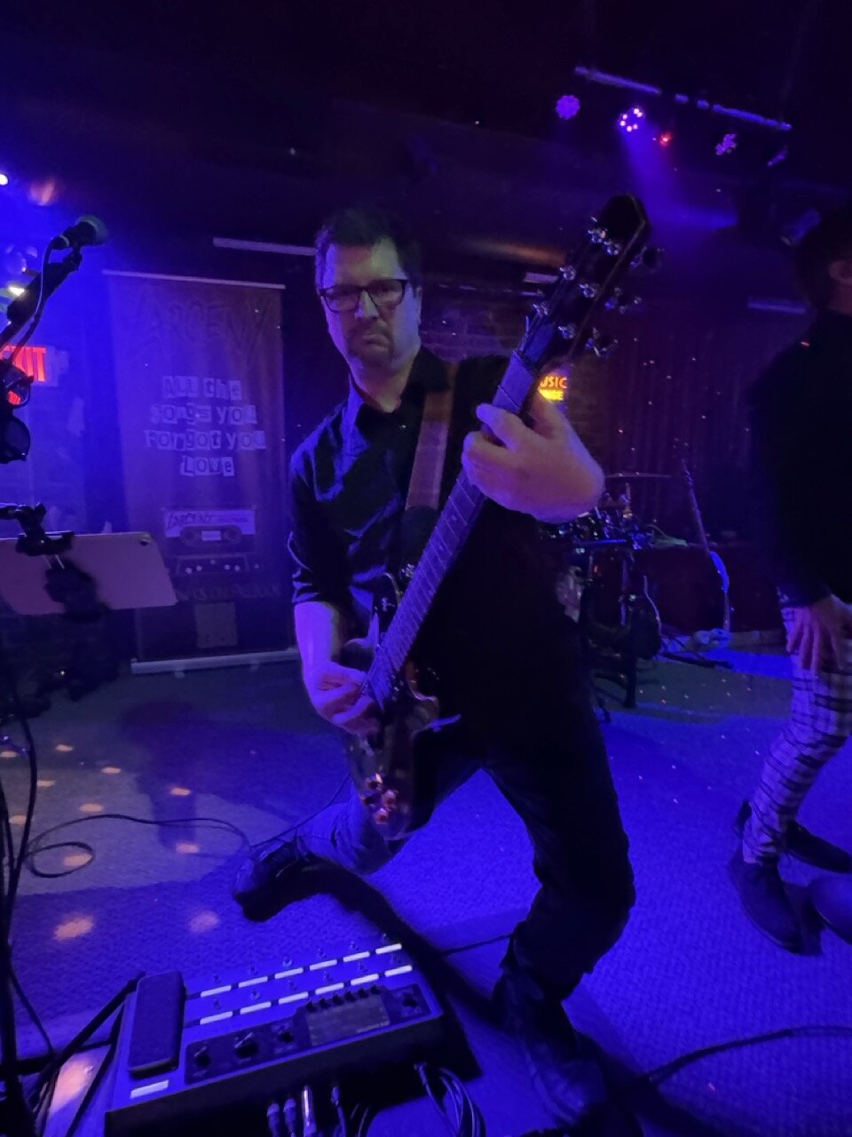 Dan Lastovka playing rhythm guitar with sunglasses